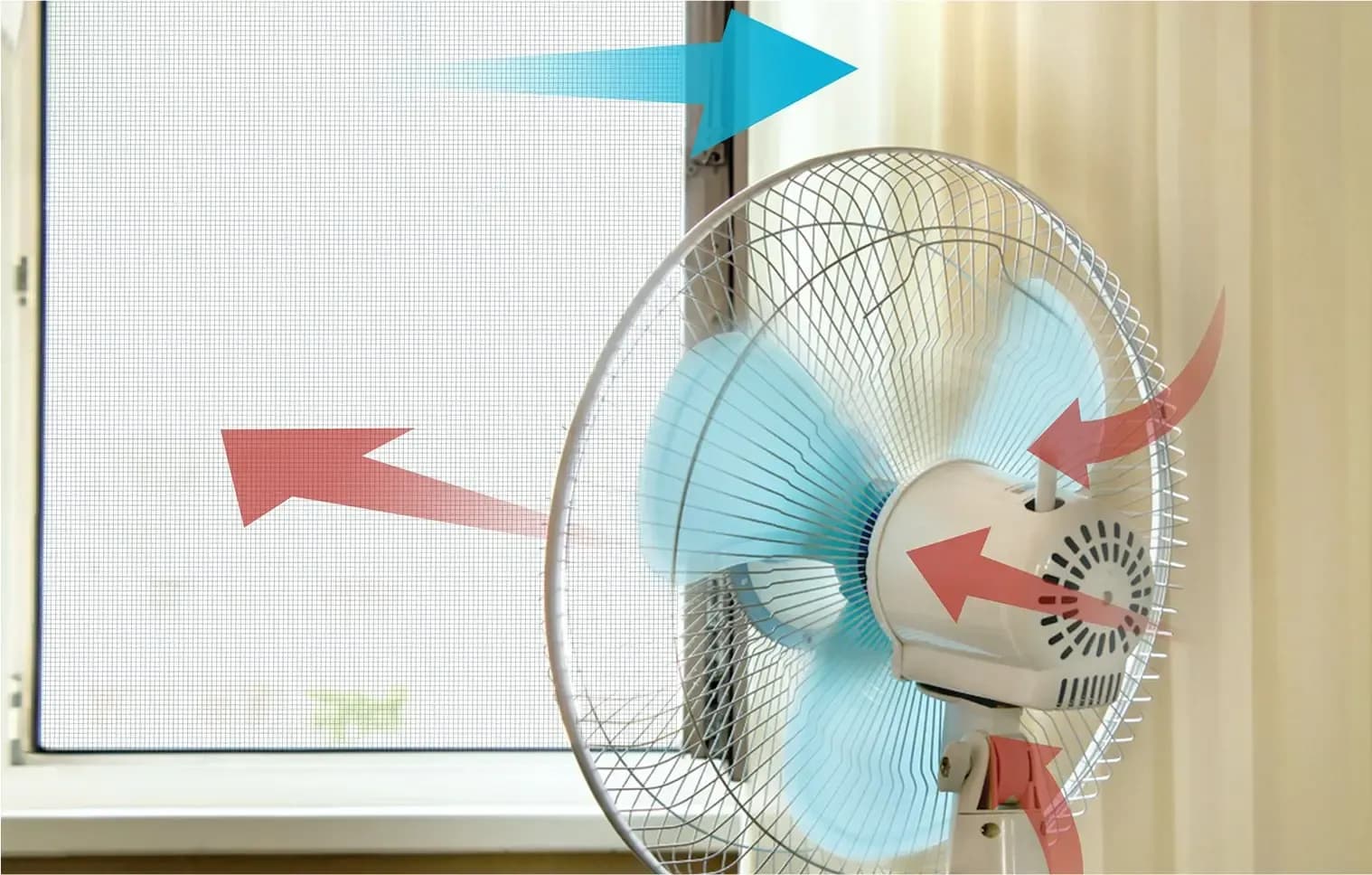 Electric fan in front of window blowing in outdoor fresh air and blowing out stale air from inside for better ventilation