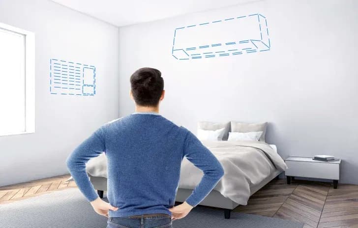 A homeowner visualizing the placement of a window type and split type aircon in their bedroom